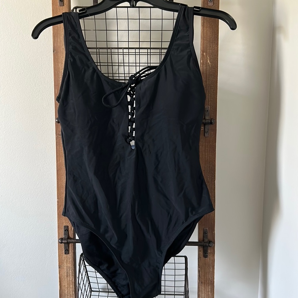 Women’s basic black scoop neck lace front one piece swimsuit.
